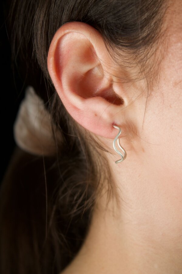 WAVI Ohrringe Nahaufnahme von geschwungenen Silberohrringen